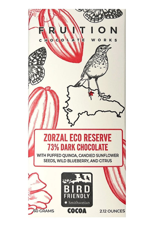 white chocolate bar wrapper with red cocoa pods and a bird featured on the front